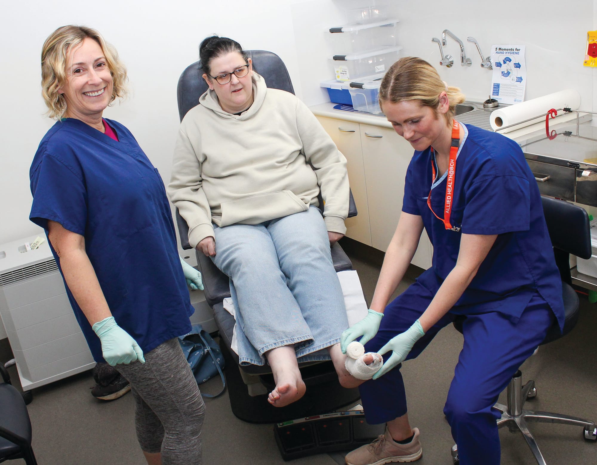 Podiatrist Rebecca Ringrose, left and Podiatrist Sally Wells consult patient Kim Watts.
