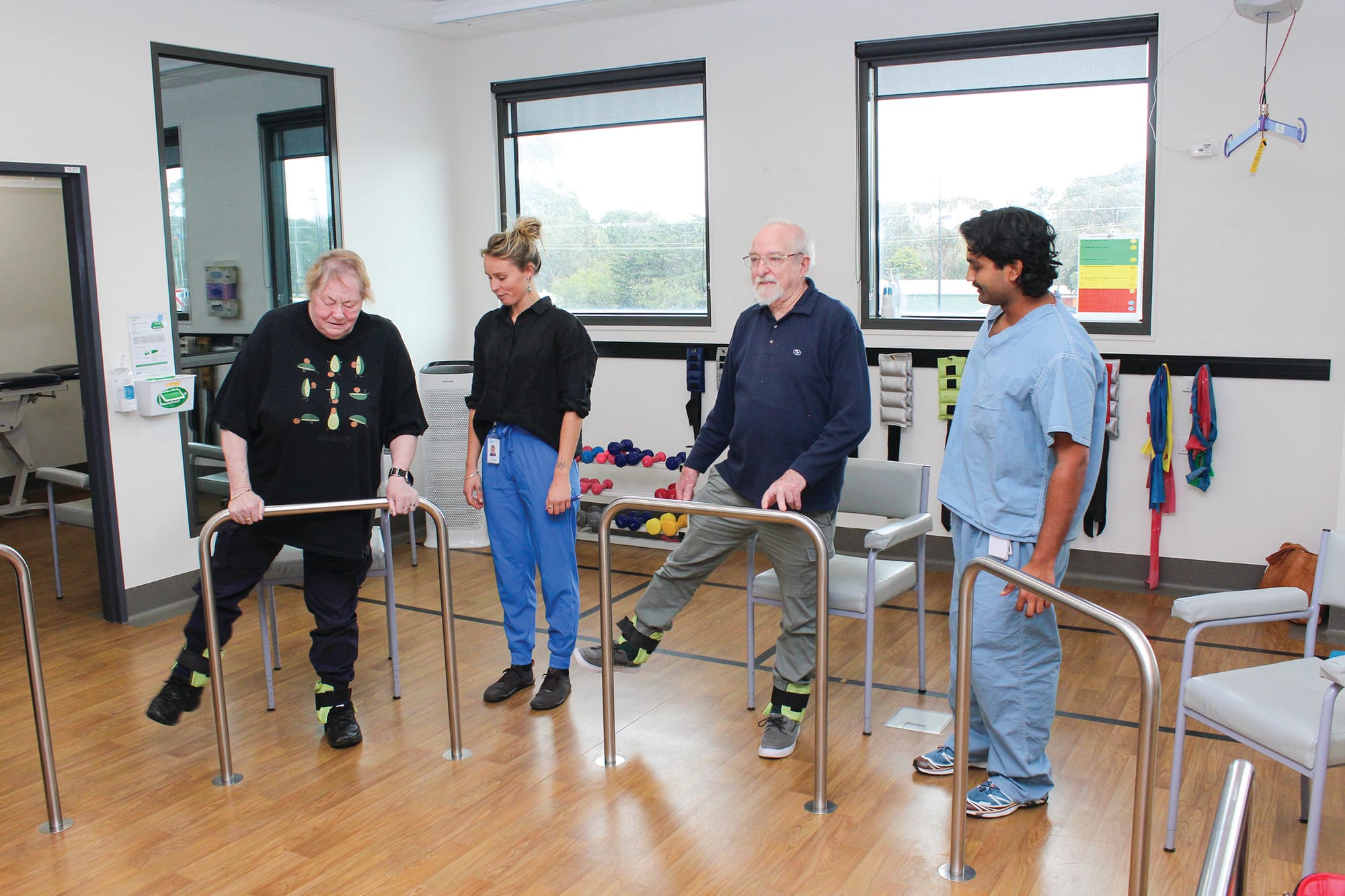 Clients Pauline Kimberley and Bob Evans are supported by Physiotherapists Maddy Smith and Kavin Jayasena during a falls group.BCH-Allied5
